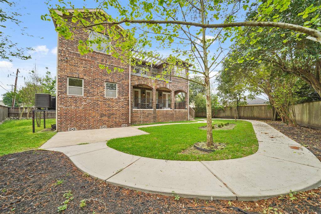 The Architecturally Designed Outdoor Living Area features 3 Arched Opening (with Brick Posts) that view the Beautifully Landscaped Backyard.  This is the Perfect Place for Friends and Family to gather for a Cook-out and Other Fun Activities!
