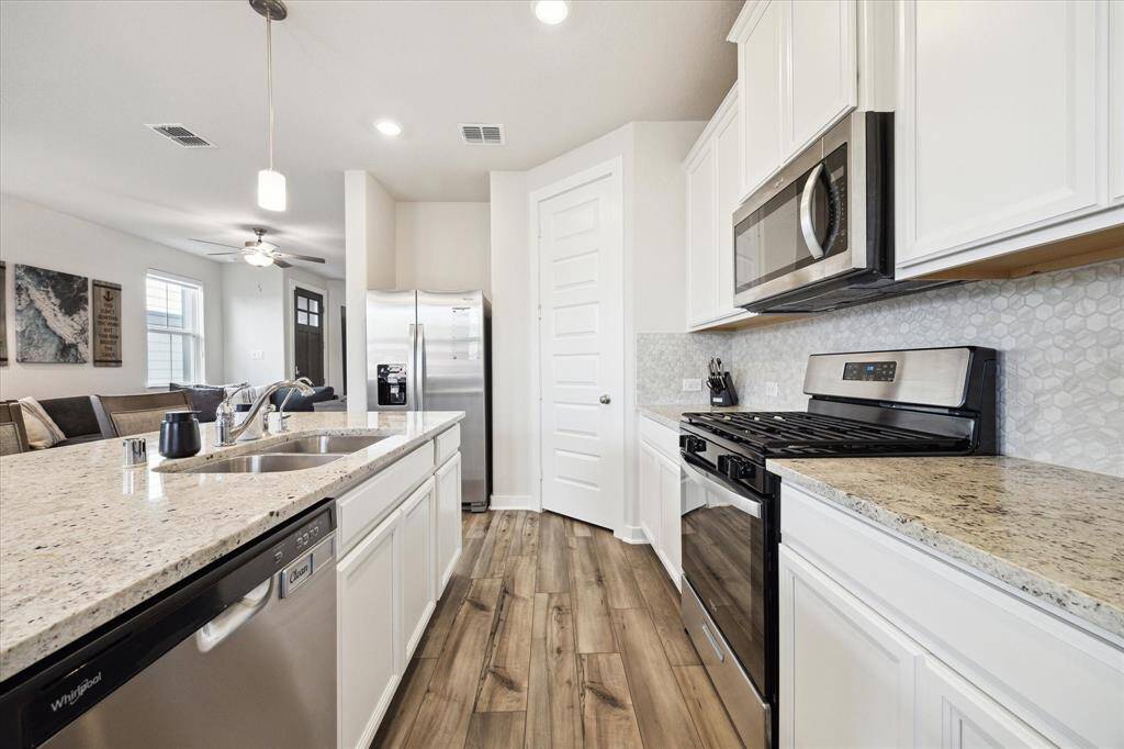 Sink includes a filter water dispenser. Walk-in pantry