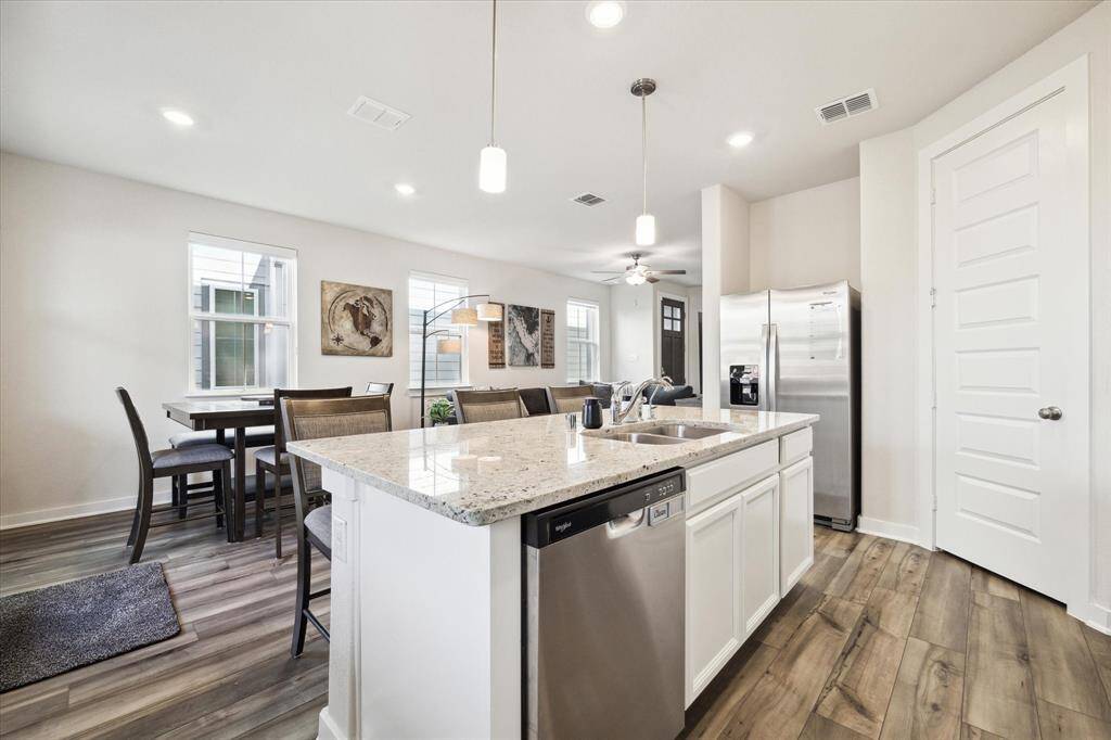 Kitchen opens up to the living and breakfast area.