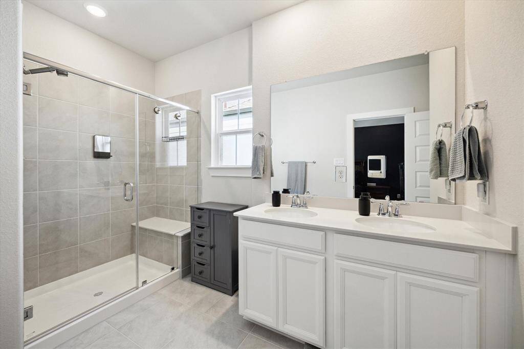 Primary bathroom with walk in shower, dual sinks and walk in closet.