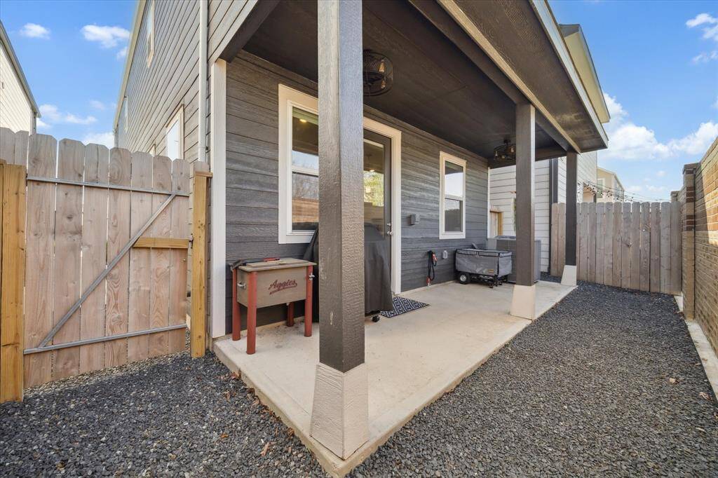 Back yard with covered patio. Fans have been installed to add more comfort when relaxing outside.