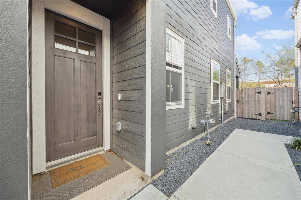 Front door is located on the right side of the home. Equipped with smart home keypad lock.