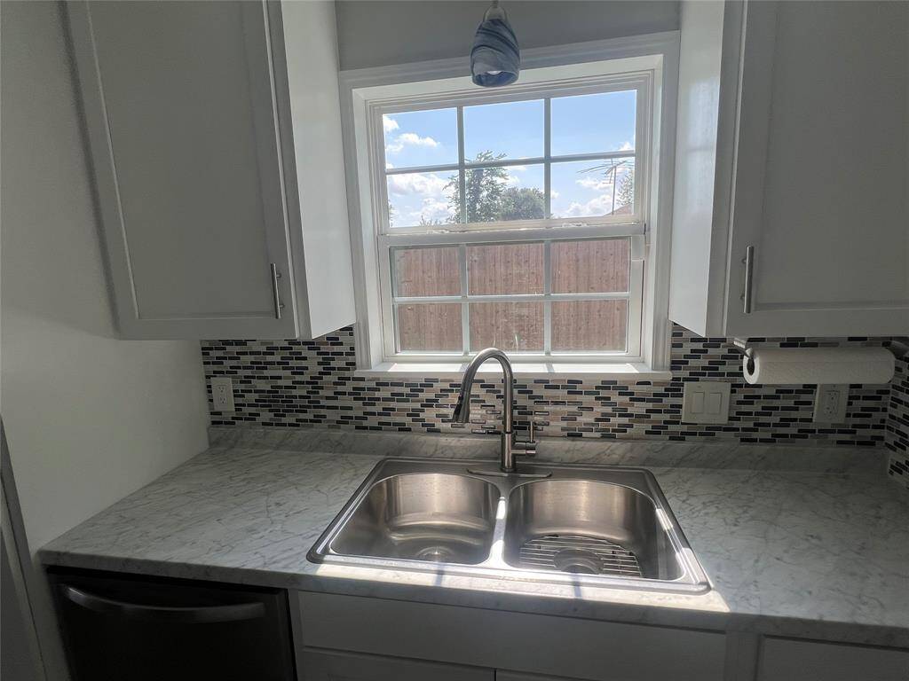 Kitchen overlooks backyard.