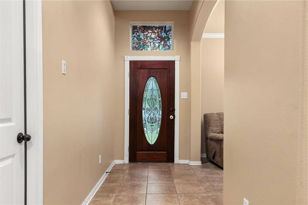 Entry with Fluted Moulding and Ceramic Tile Flooring