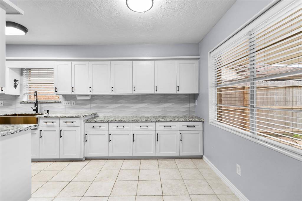 Plentiful cabinets and countertops offer abundant space to store all your kitchen appliances and make meal prepping a breeze. This room could also be used as a breakfast room, with a great view into the backyard with covered back patio.