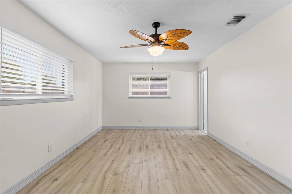 The 18 x 12 primary suite faces the back and side yards and is installed with luxury vinyl plank.