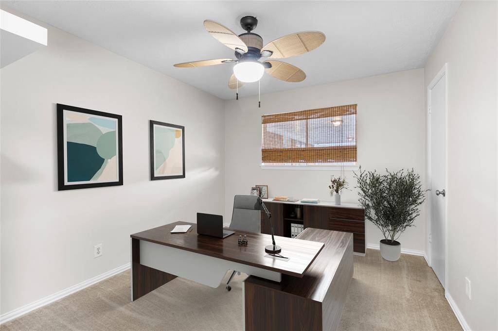 Bedroom 3 faces the backyard, with a view into the back patio. This room is perfect for a home office!*Virtually Staged