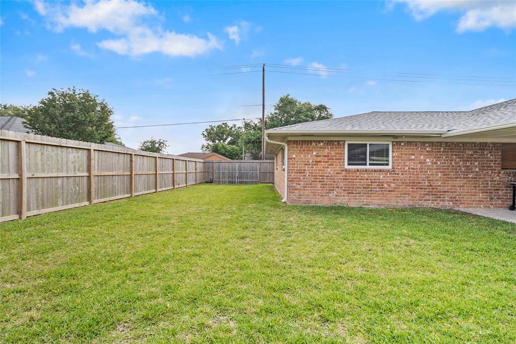 The 2 year old fence gives peace of mind. The backyard offers plenty of storage for your trailers, boats, or other equipment with access through the double gates pictured in the middle.