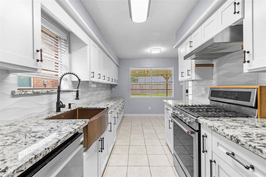 The kitchen features updated Quartz countertops, updated cabinetry with modern hardware, and a gorgeous farmhouse copper sink.