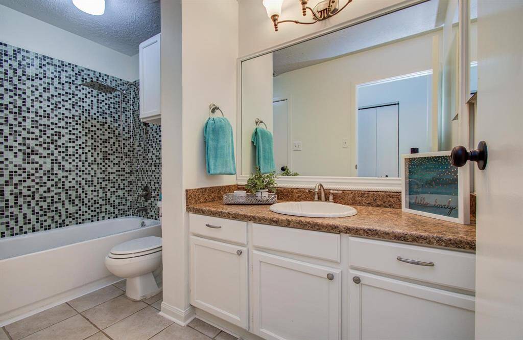 Upstairs bathroom with shower/tub combo and oversized sink area.