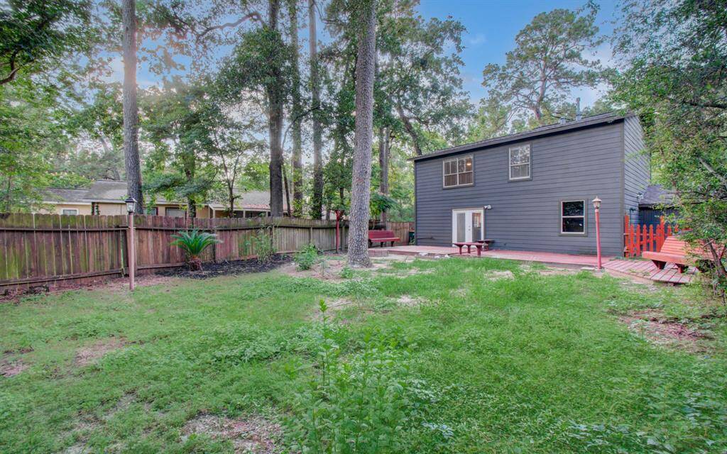Large tree lined back yard.