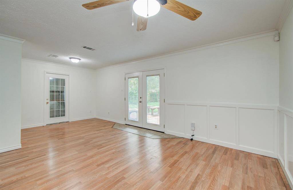 Living room/Dining room combo with beautiful wainscoting detail.