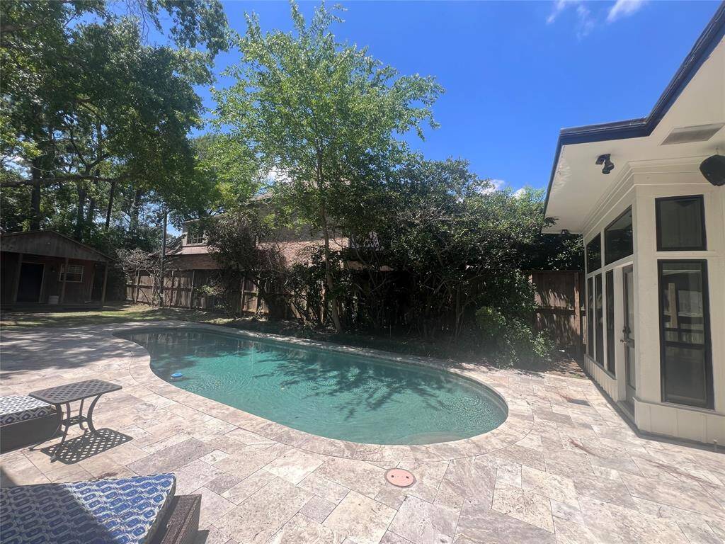 The backyard oasis with swimming pool and flagstone patio is perfect for your family and friends gatherings