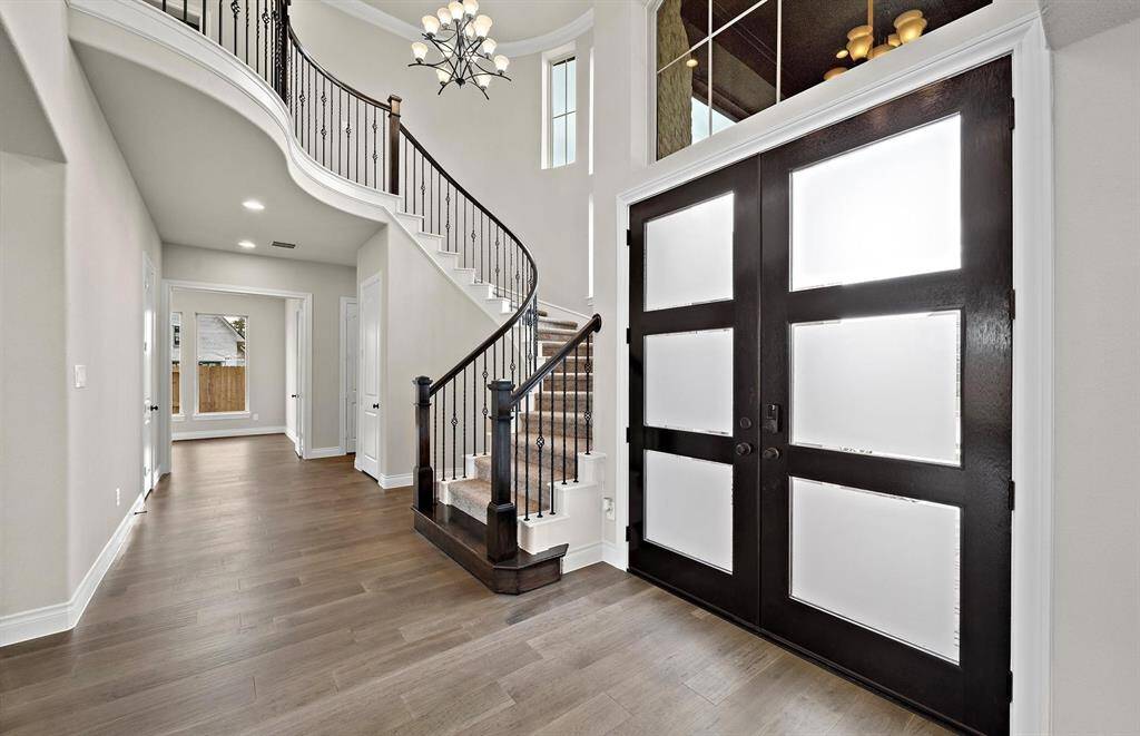 The sweeping staircase adds a dramatic focal point, setting the tone for the luxury and style found throughout this home.