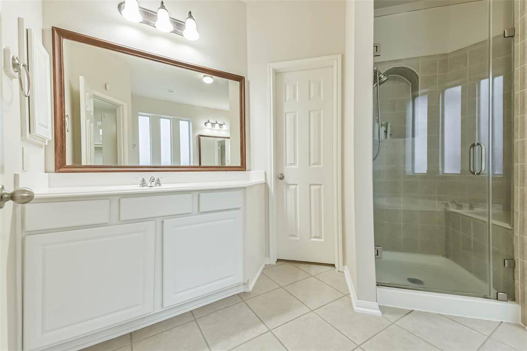 The bathroom has a garden tub and a separate shower.
