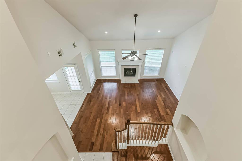 View from the game room area upstairs looking down into the living room.