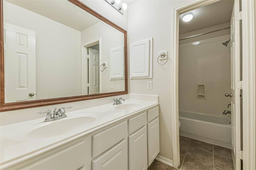 The upstairs full bathroom has double sinks.