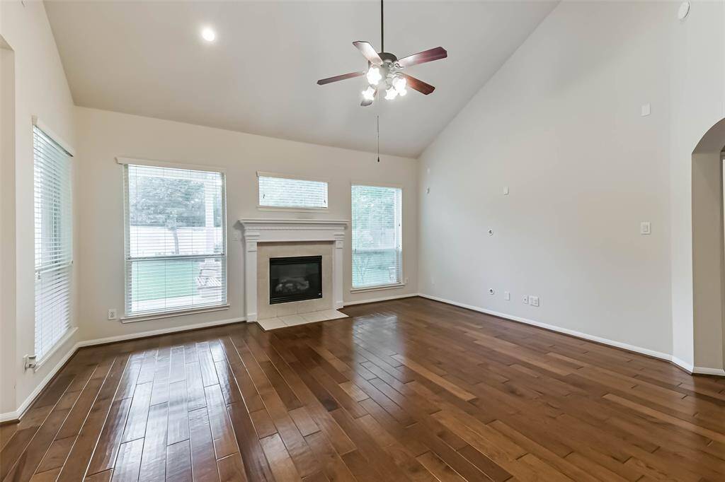 Large living room with a fireplace and lots of natural lightl