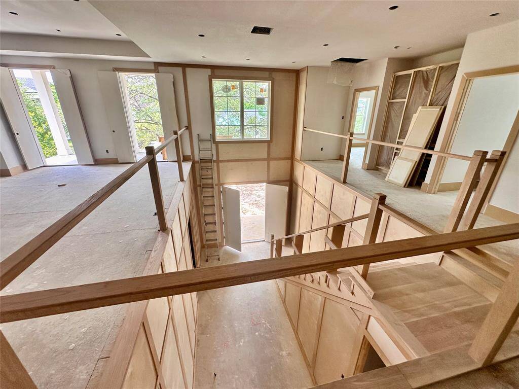 View of foyer from upstairs - look at all the natural light even on this cloudy day.