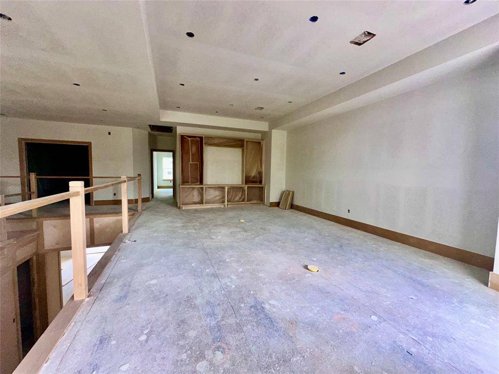 Family room upstairs with doors leading to balcony behind photographer