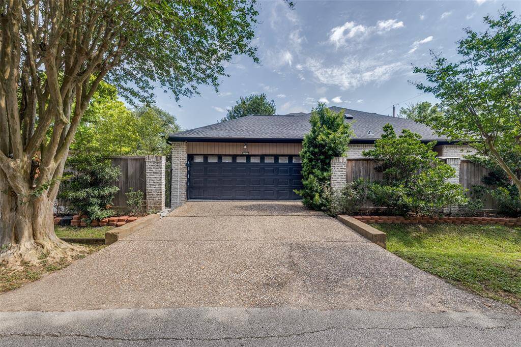 The brick walkway takes you to the covered porch entrance and double doors. The sprinkler system covers the front and back yard.