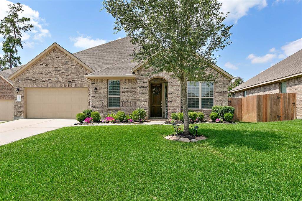 Charming single-story brick home with a well-maintained lawn and a welcoming front entrance.