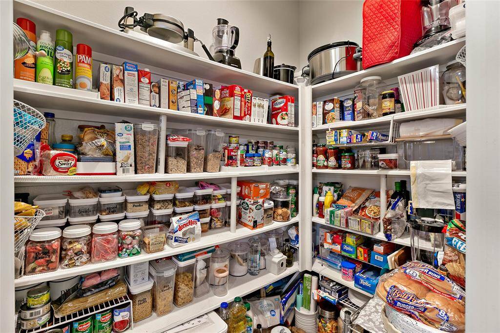 Large walk in pantry with plenty of shelving and storage.