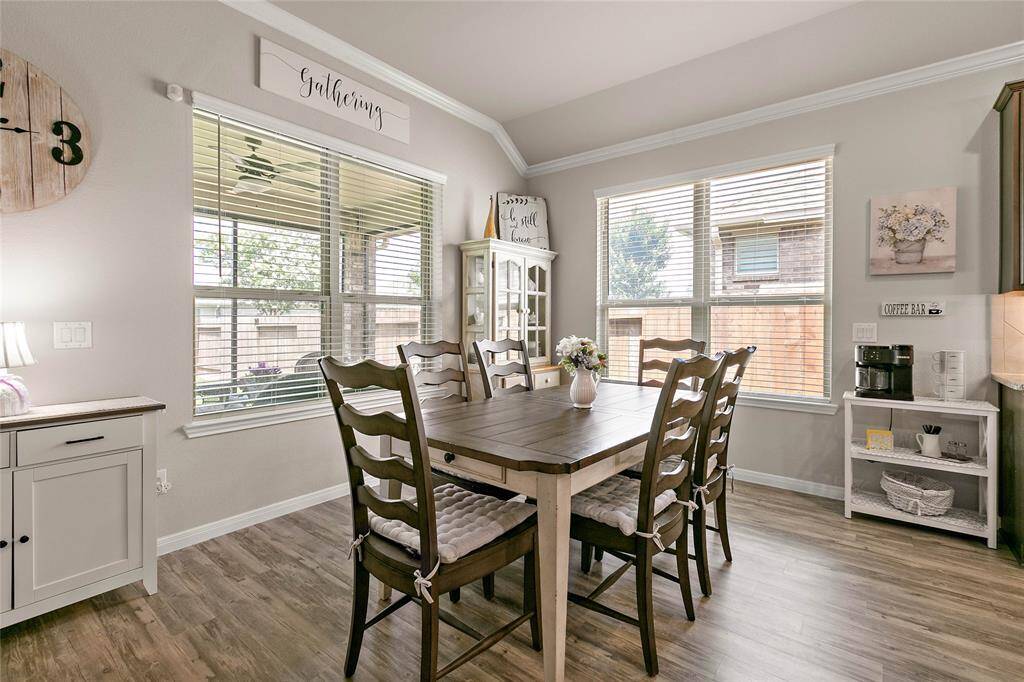 The dining area features a cozy, well-lit space with large windows.