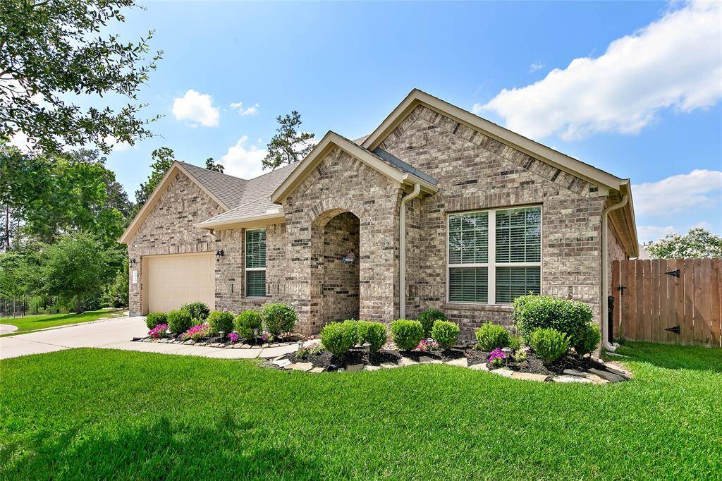 Front yard featuring manicured shrubs and colorful flowers.