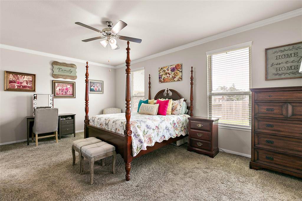Oversized primary bedroom with views of the serene backyard.