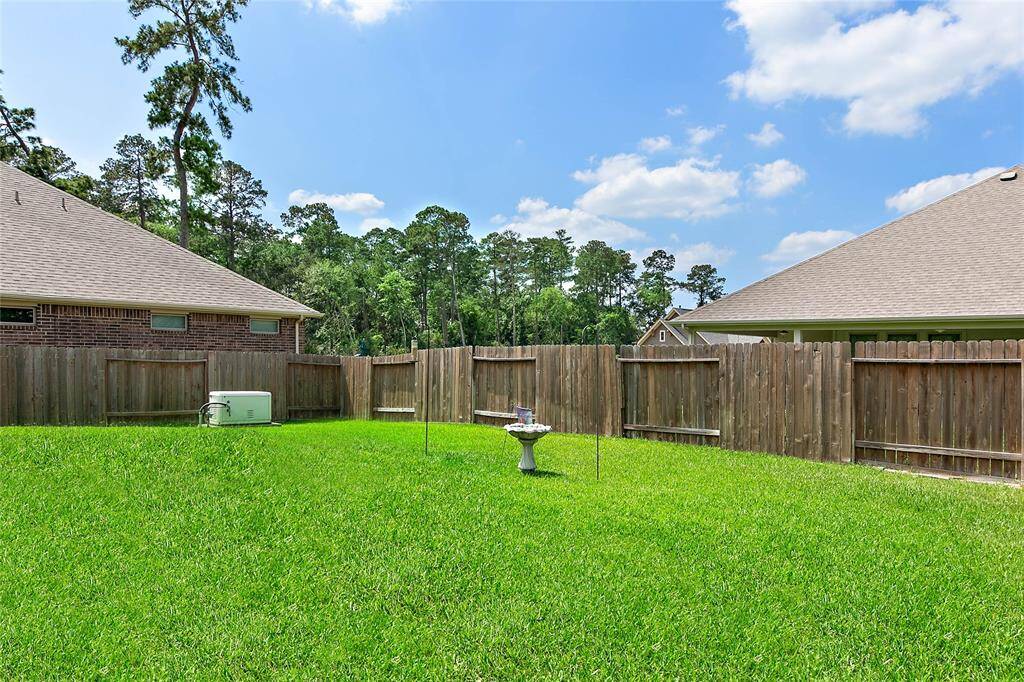 Spacious fully fenced backyard with full yard sprinkler.
