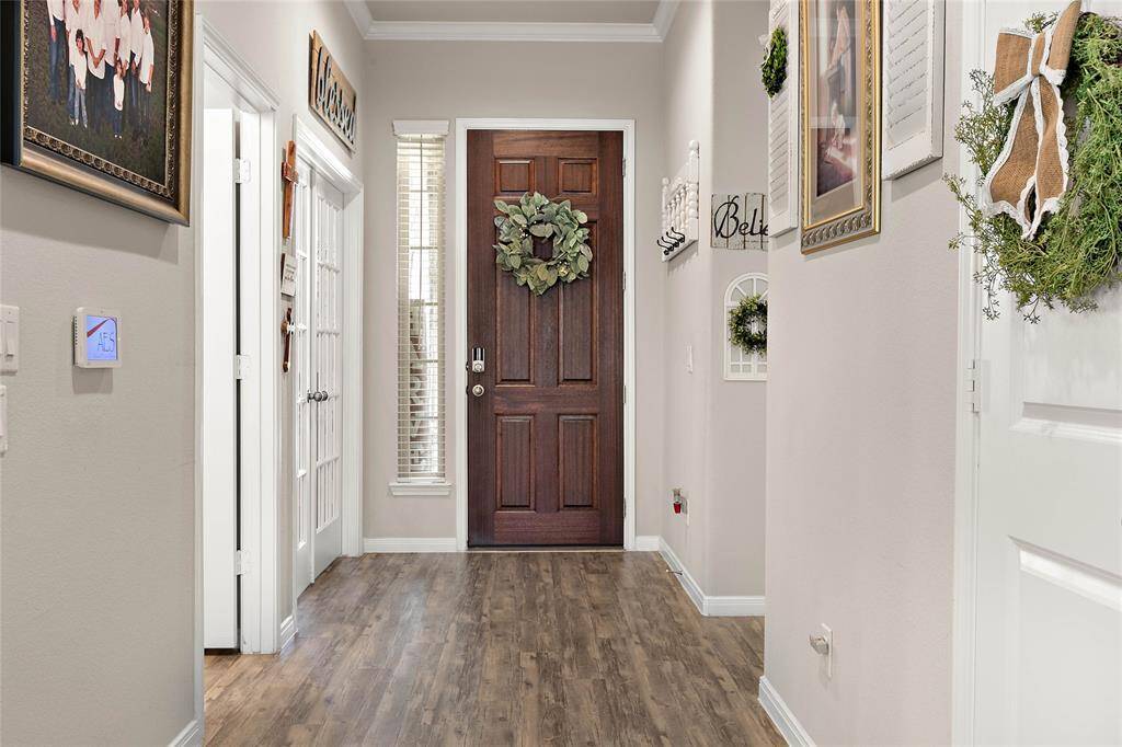 Welcoming entryway with wood floors and large hallway.