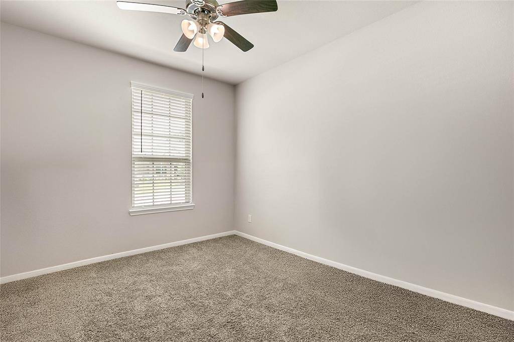Second bedroom with ensuite bathroom comes complete with carpet and ceiling fan overlooking the front yard.
