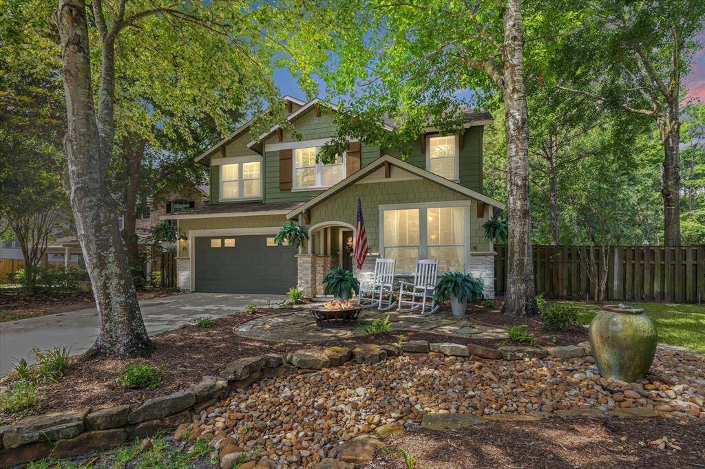 Evening curb appeal radiates from this charming Craftsman at 15 Forest Perch Drive. Nestled on a peaceful cul-de-sac street and framed by mature trees and lush landscaping, the home welcomes you with a cozy front porch and thoughtfully designed garden—setting the tone for the warmth found inside.