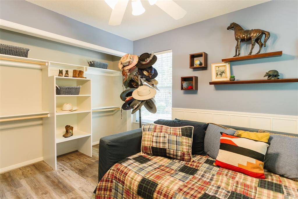 This charming bedroom boasts Wood-look vinyl flooring and soft blue tones add warmth, while natural light fills the room for a cozy, inviting feel.