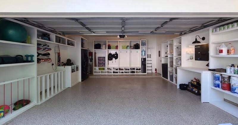 An alternate view of the finished garage highlights the small pegboard workstation—ideal for keeping frequently used tools organized and within reach. Clean lines, custom shelving, and a designated workbench area make this a highly functional and well-appointed space.