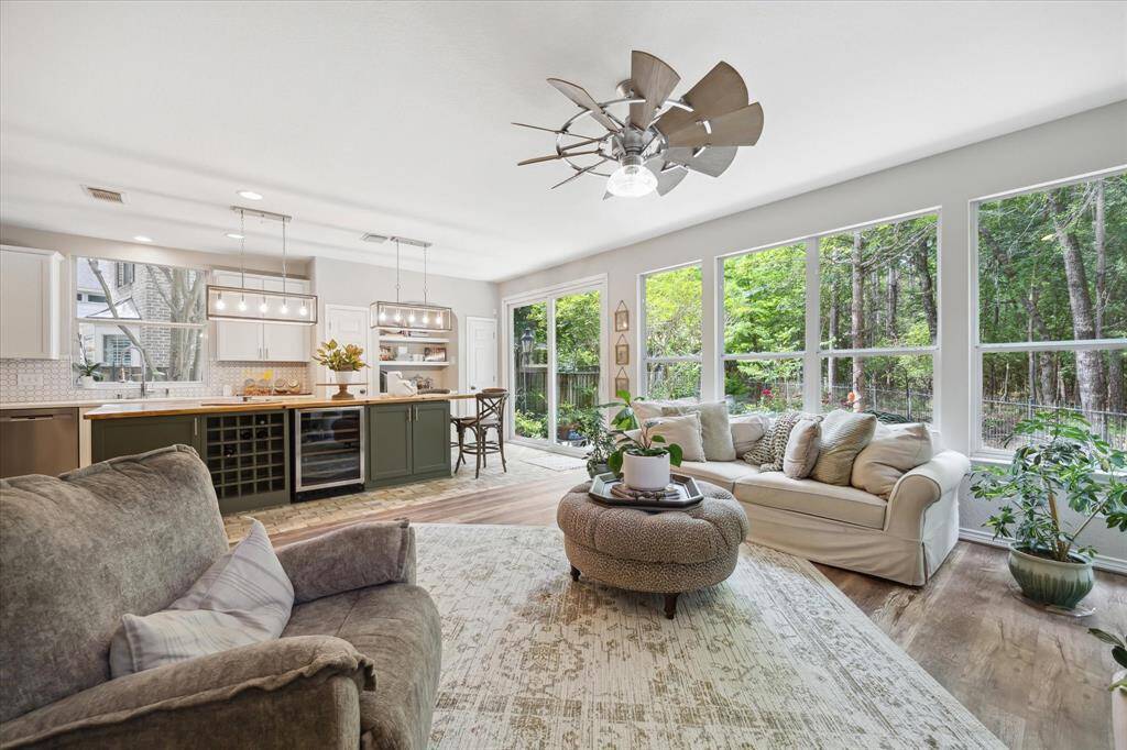 A fresh, open layout connects the kitchen seamlessly to the living and dining areas, offering garden views and easy access to outdoor entertaining.