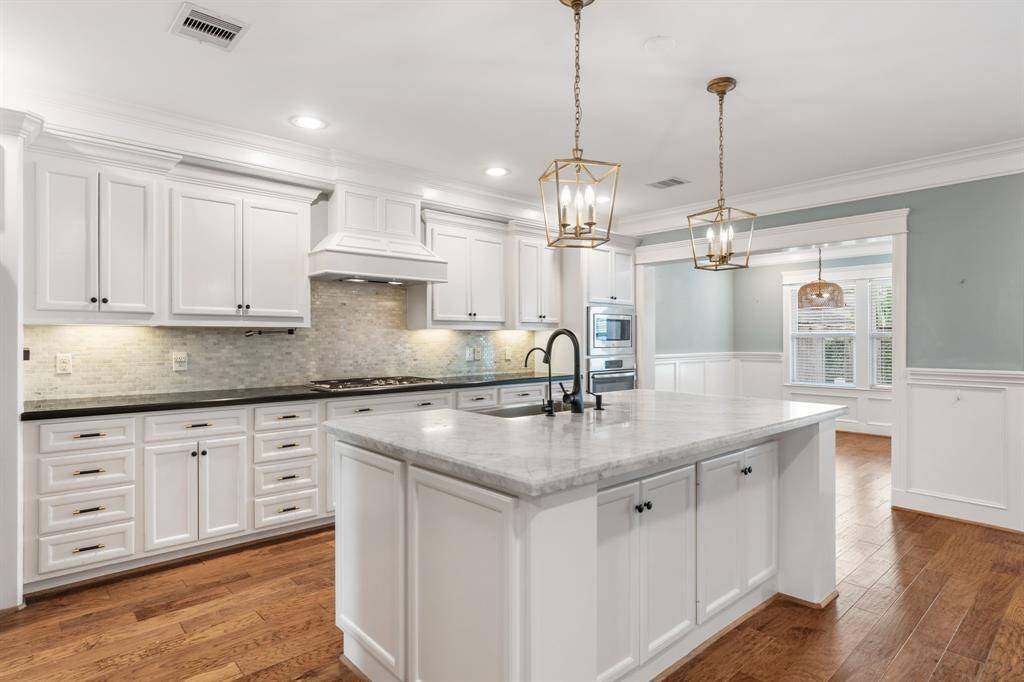 This kitchen also offers under cabinet lighting and a custom hood vent.