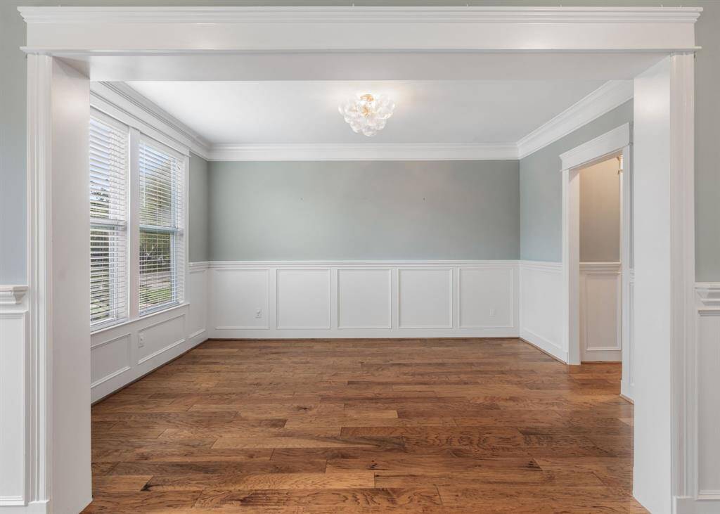 The wainscot and hardwood floors continue throughout the home.