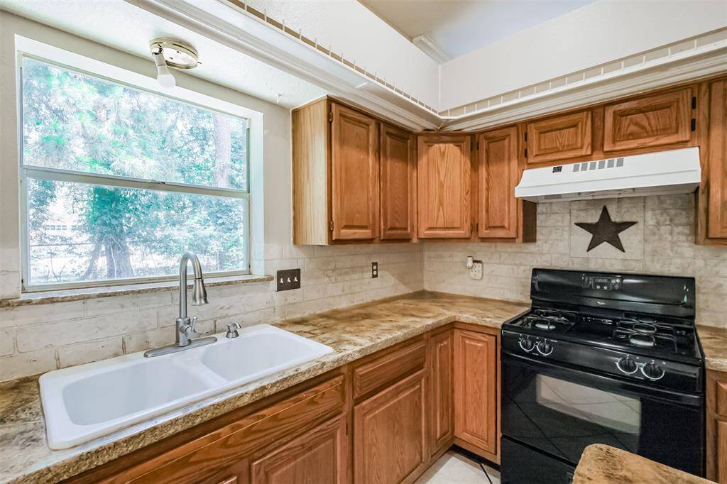 Kitchen sink with a window above, bringing in natural light.