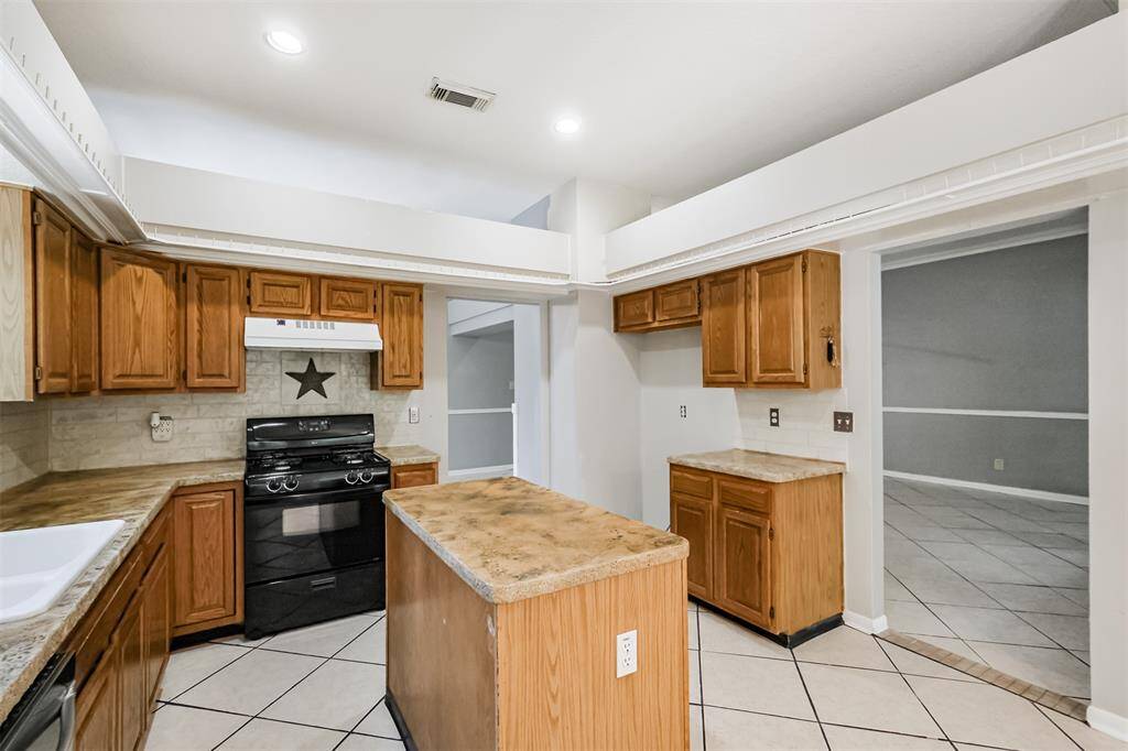 Recessed lighting highlights the backsplash, adding subtle style to the space.
