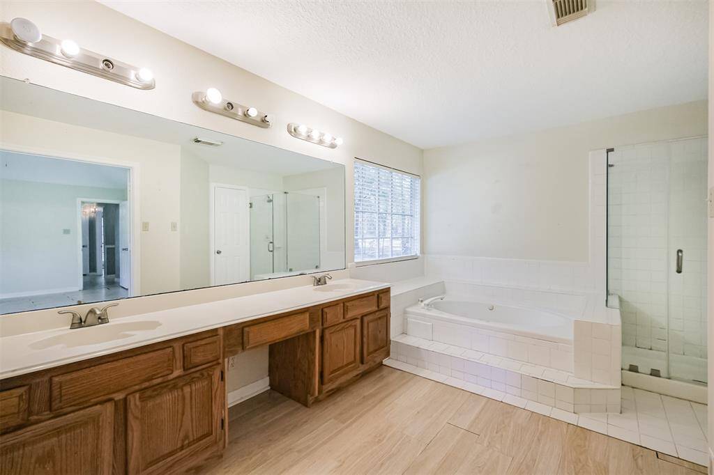 Bathroom offers dual sinks and ample counter space.