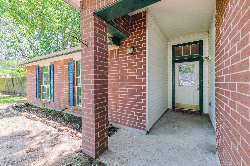 Covered front stoop with a transom window adding light above the entry.