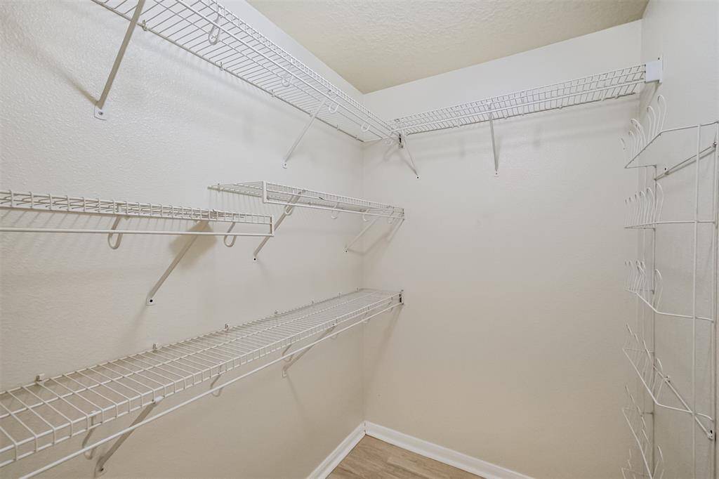 Walk-in closet with built-in organization options for easy storage.
