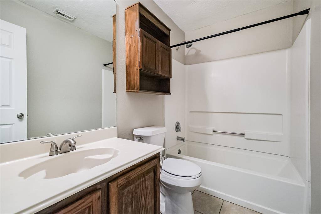 Secondary bathroom features tile flooring and a shower/tub combo.