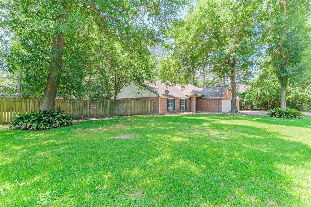 Spacious lot with mature shade trees offering a peaceful outdoor setting.