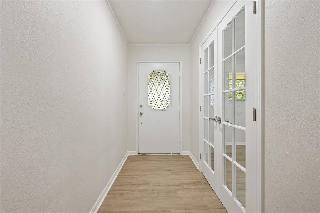 Front door entry view; French doors lead to the home office so working at home or keeping the family organized in your own spot!