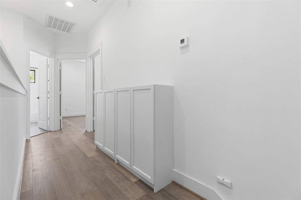 Extra Built-in Hallway Storage leading up to Secondary Rooms and Full Bath