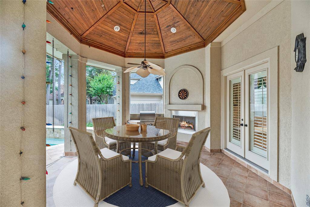 Gorgeous covered patio w/built in grill, gas log fireplace, outdoor ceiling fan - has direct access from the primary bedroom, guest quarters, & study/formal dining! Virtually staged for your designing ideas.