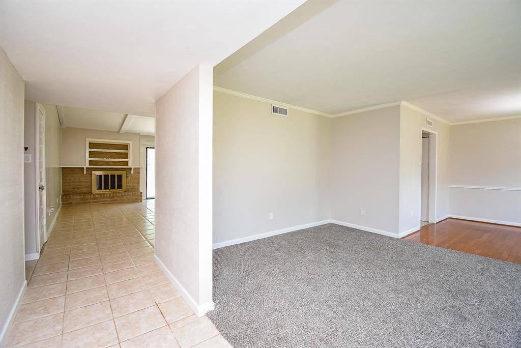 Stepping inside, your eye is drawn to a cozy den straight ahead and a multi-use living space off to the side. The layout feels fluid, offering a sense of openness without giving everything away at once.